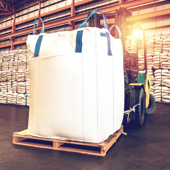 Bulker Bag on pallet handled by forklift in warehouse.