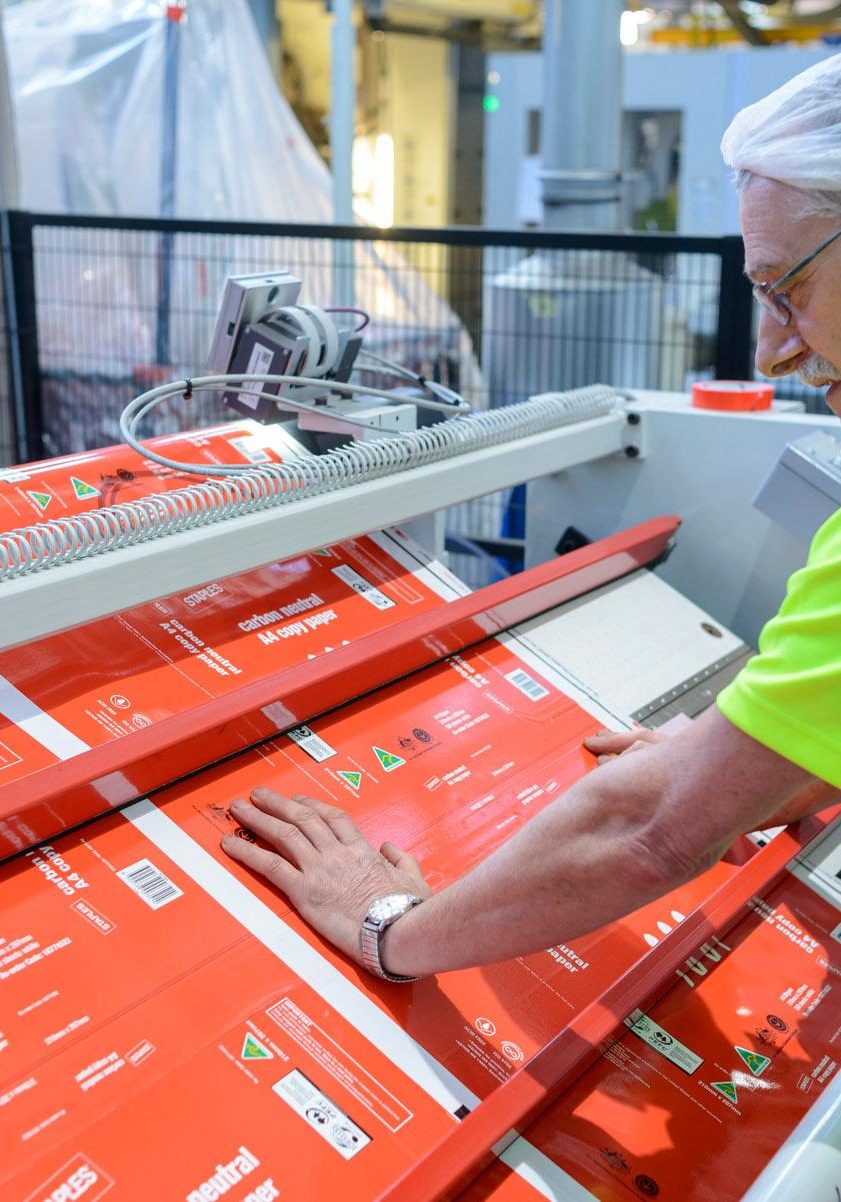 Man looking at laminated sample Laminated Products showing barrier protection with printed film for shelf life sealing.